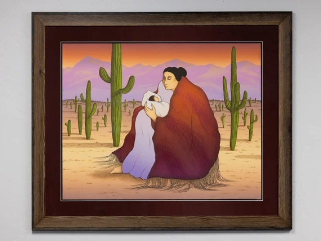 a photo of a lithograph in a frame showing a Native American woman holding a swaddled baby in the desert surrounded by saguaros