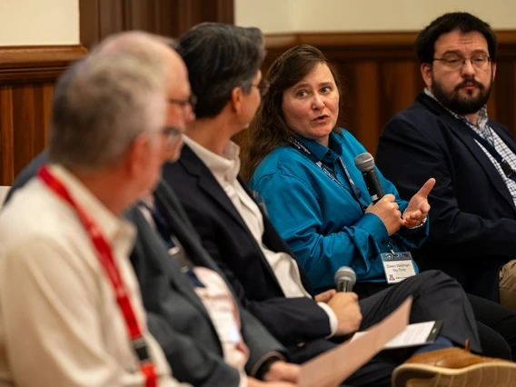 Dawn Wellman speaking to other people sitting on a panel presentation