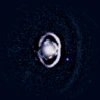 The star, WISPIT 2, appears a bright spot in the center, surrounded by a white, bright ring of dust. Two small dots indicate the growing protoplanets in the system. 